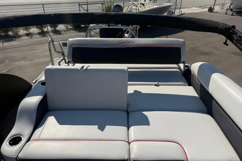 Slide: The Image of 2022 Barletta Corsa 23U boat interior with plush seating and cup holders. - 7