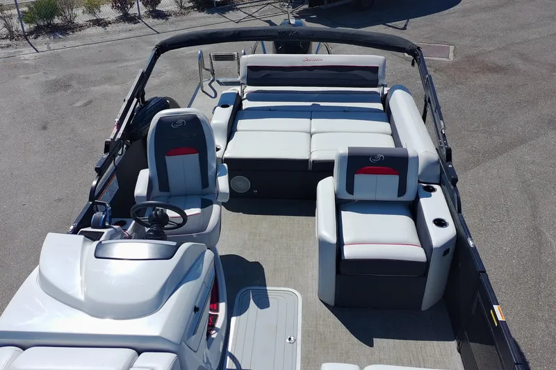 Slide: The Image of 2022 Barletta Corsa 23U pontoon boat interior with plush seating and steering console. - 8
