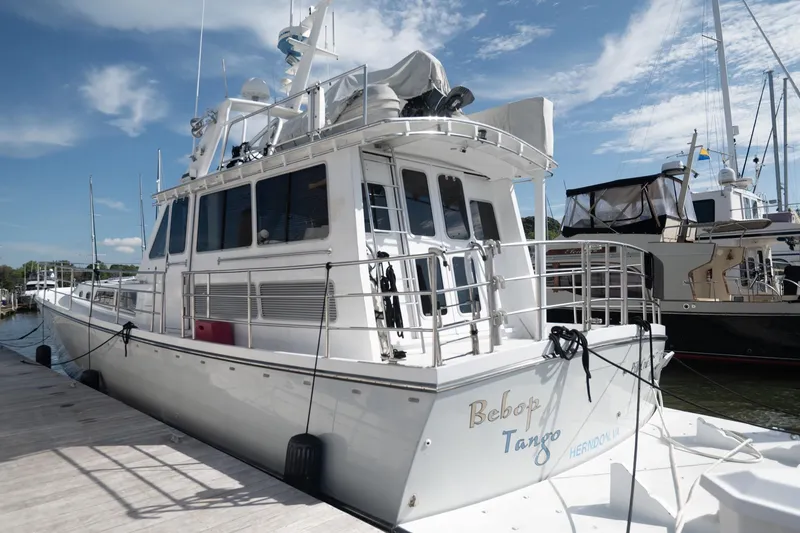 Slide: The Image of 2007 Pilot Cruiser Expedition boat docked at marina under blue sky. - 1