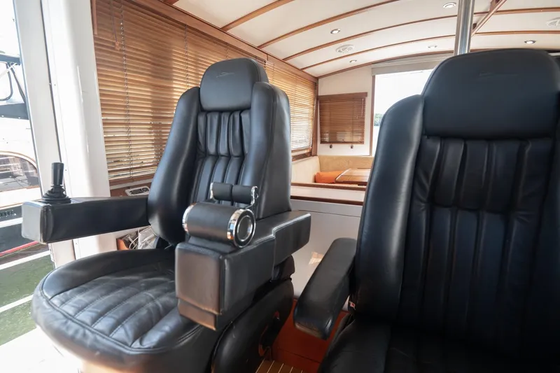 Slide: The Image of Luxurious leather seats in a 2007 Pilot Cruiser Expedition yacht interior. - 23