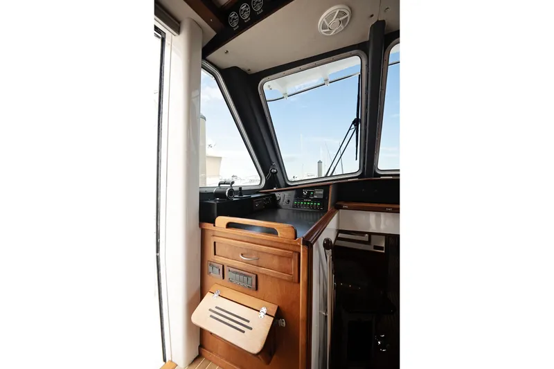 Slide: The Image of 2007 Pilot Cruiser Expedition boat interior with control panel and wooden cabinetry. - 27