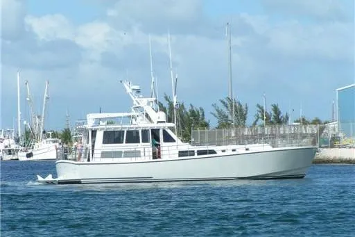 Slide: The Image of 2007 Pilot Cruiser Expedition boat on water, clear sky, marina background. - 3