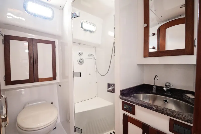 Slide: The Image of 2007 Pilot Cruiser Expedition yacht bathroom with shower, sink, and wooden cabinets. - 41