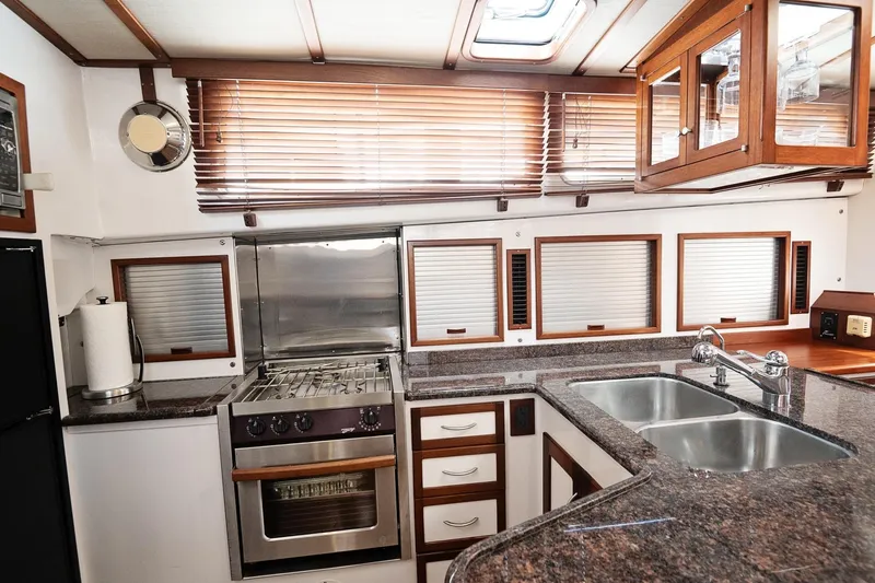 Slide: The Image of Luxurious 2007 Pilot Cruiser Expedition yacht kitchen with modern appliances and wooden cabinetry. - 54