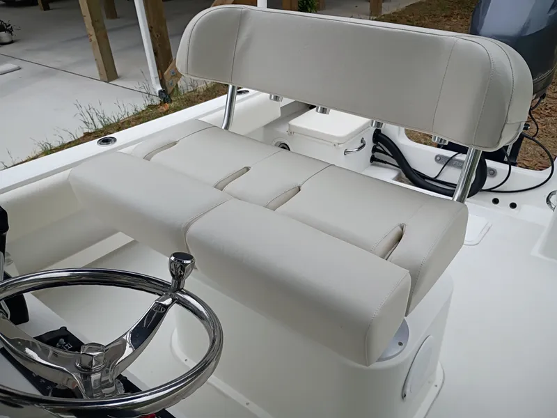Slide: The Image of Interior of a 2016 Parker 23SE boat with white seating and steering wheel. - 14