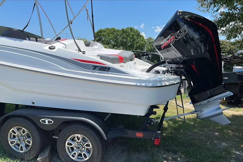 Slide: The Image of 2026 Tahoe T21 boat on trailer with Mercury Pro XS engine, parked outdoors. - 3