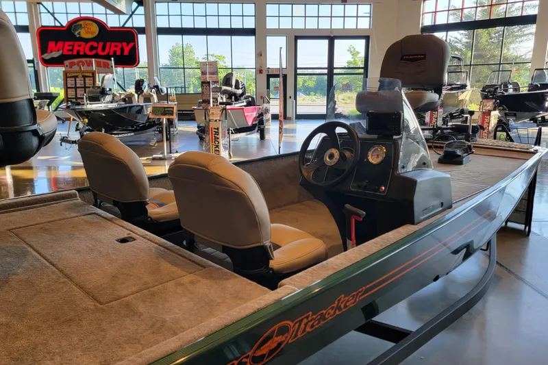 Slide: The Image of 2026 Tracker Bass Tracker Classic Limited boat displayed in showroom with Mercury signage. - 3