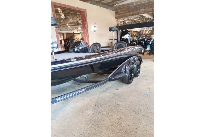 The Image of 2026 Ranger Z518 Cup-Equipped boat displayed indoors, showcasing sleek design and dual axles. - 0