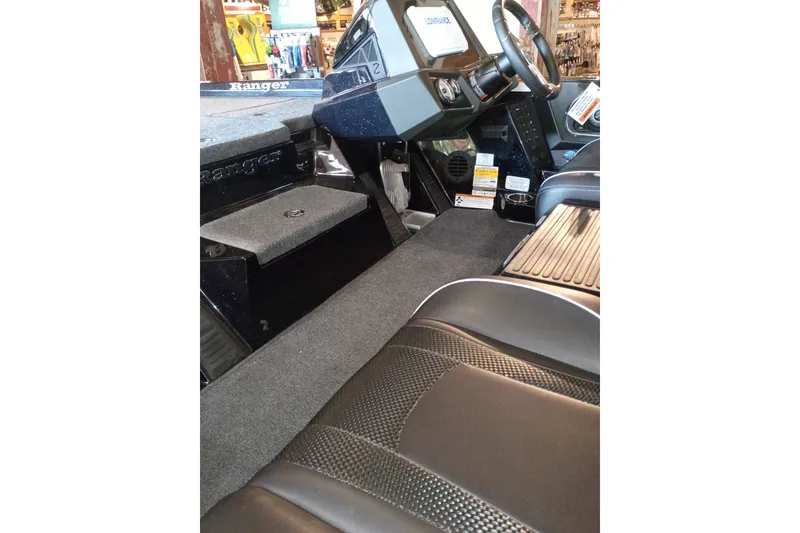 Slide: The Image of Interior of 2026 Ranger Z518 Cup-Equipped boat, featuring steering console and seating. - 1