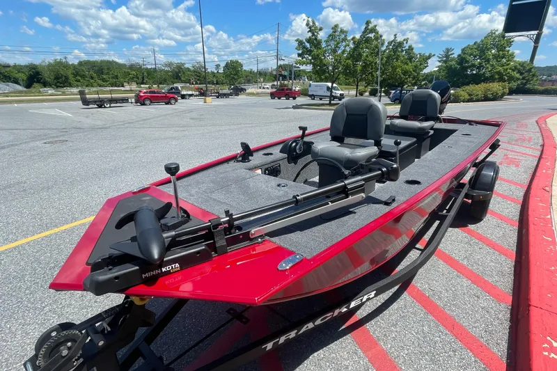 Slide: The Image of 2026 Tracker Panfish 17 boat in parking lot, featuring Minn Kota trolling motor. - 2