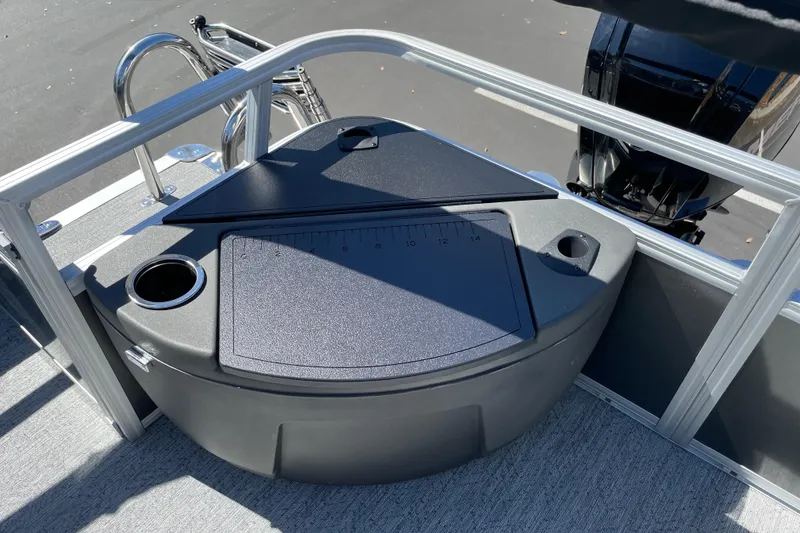 Slide: The Image of 2026 Sun Tracker Bass Buggy 18 DLX boat deck with storage compartment and cup holders. - 26