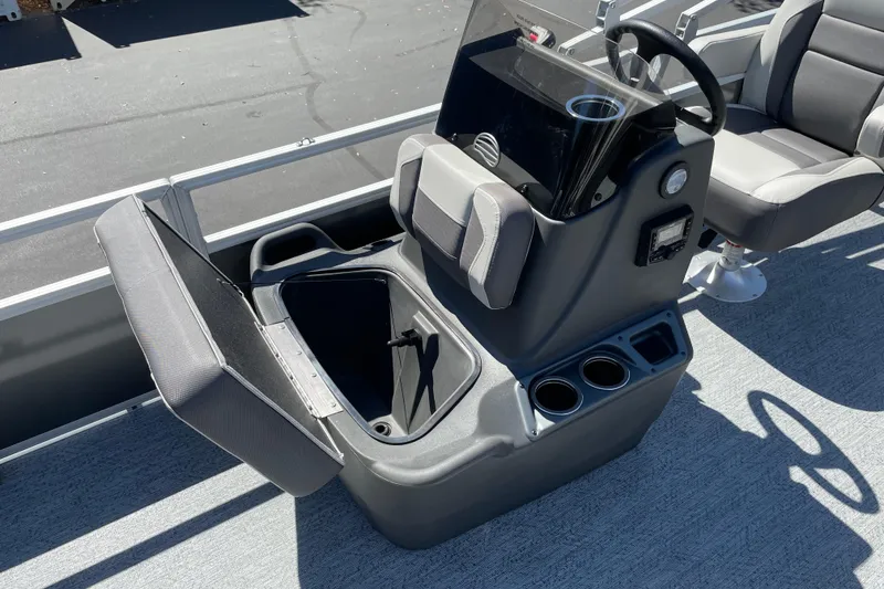 Slide: The Image of 2026 Sun Tracker Bass Buggy 18 DLX boat console with storage compartment and seating. - 16