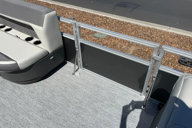 Slide: The Image of 2026 Sun Tracker Bass Buggy 18 DLX pontoon boat interior with seating and railing. - 32