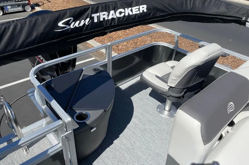 Slide: The Image of 2026 Sun Tracker Bass Buggy 18 DLX pontoon boat interior with seating and console. - 25