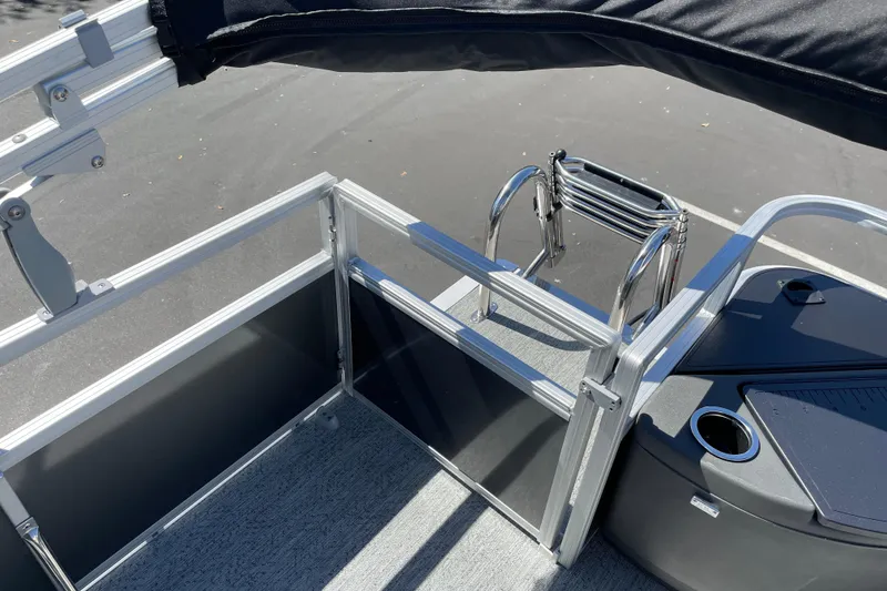 Slide: The Image of 2026 Sun Tracker Bass Buggy 18 DLX pontoon boat with ladder and railing details. - 31
