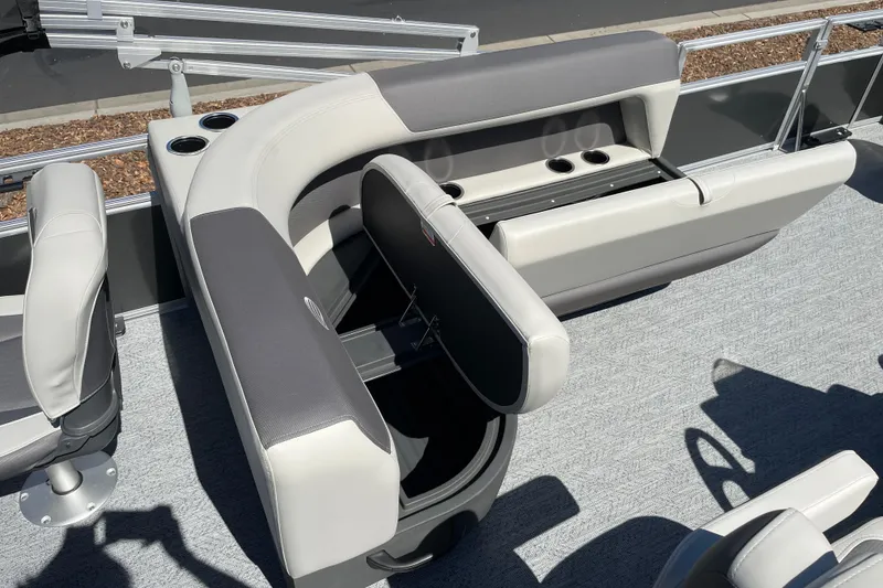 Slide: The Image of 2026 Sun Tracker Bass Buggy 18 DLX pontoon boat interior with seating and cup holders. - 20