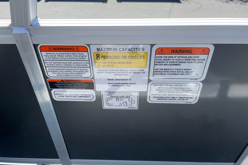 Slide: The Image of Warning labels on 2026 Sun Tracker Bass Buggy 18 DLX boat, indicating capacity and safety instructions. - 34