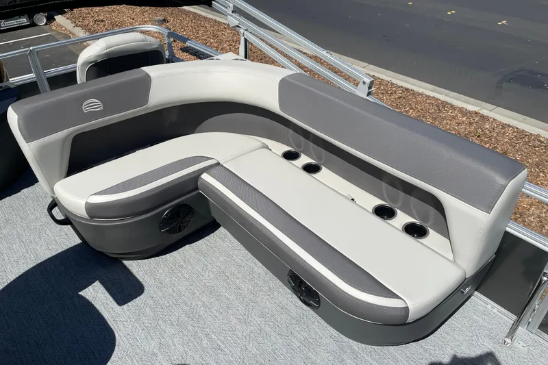 Slide: The Image of 2026 Sun Tracker Bass Buggy 18 DLX pontoon boat seating with cup holders and speaker. - 18