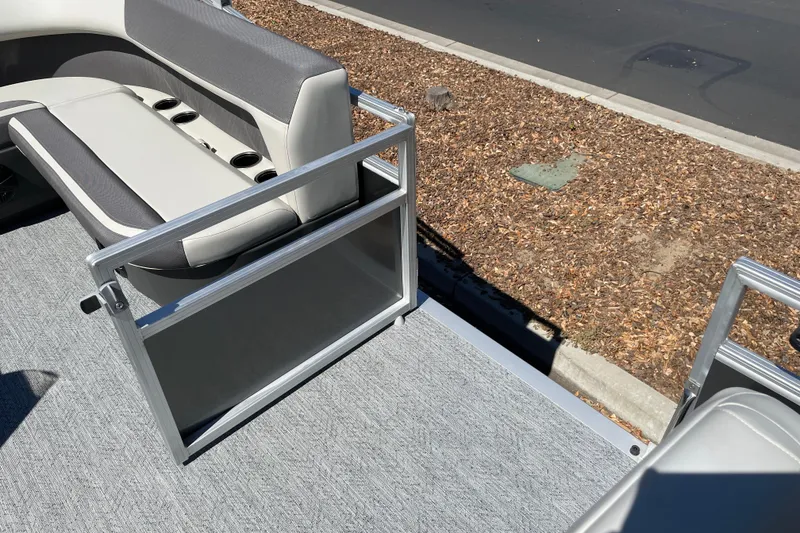 Slide: The Image of 2026 Sun Tracker Bass Buggy 18 DLX pontoon boat interior with seating and railing. - 33