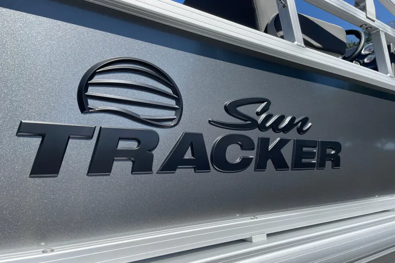 Slide: The Image of 2026 Sun Tracker Bass Buggy 18 DLX logo on metallic surface. - 36