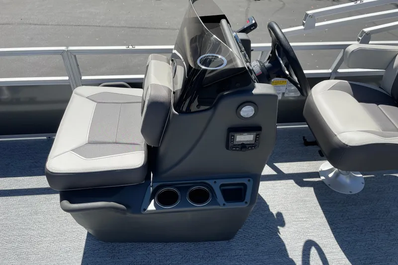 Slide: The Image of 2026 Sun Tracker Bass Buggy 18 DLX boat interior with steering console and seating. - 15