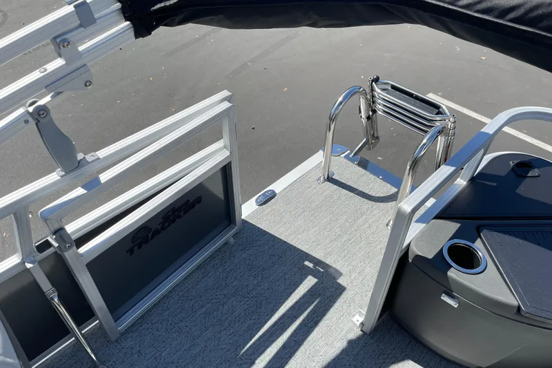Slide: The Image of 2026 Sun Tracker Bass Buggy 18 DLX boat deck with ladder and railing. - 30