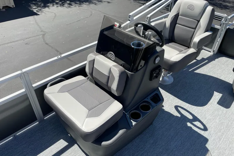 Slide: The Image of 2026 Sun Tracker Bass Buggy 18 DLX pontoon boat interior with steering console and seating. - 14