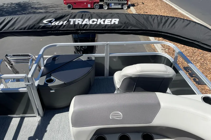 Slide: The Image of 2026 Sun Tracker Bass Buggy 18 DLX pontoon boat interior with seating and storage. - 24