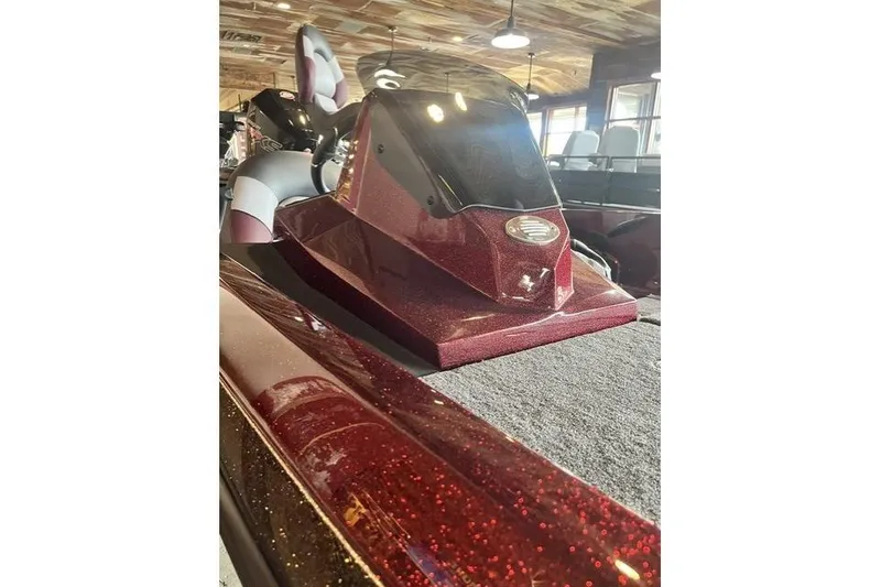 The Image of 2026 Ranger Z185 boat with sparkling maroon finish in a showroom setting. - 0