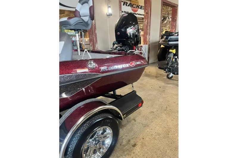 Slide: The Image of 2026 Ranger Z185 boat in showroom, featuring sleek design and shiny maroon finish. - 8