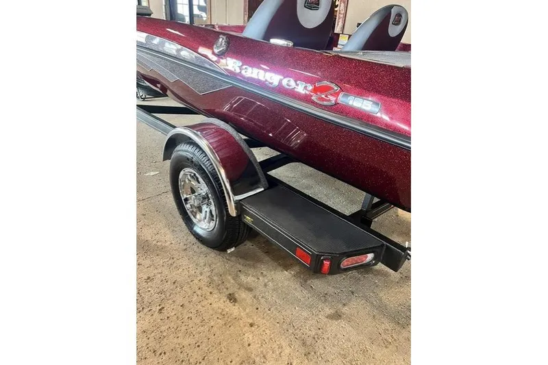 Slide: The Image of 2026 Ranger Z185 boat on trailer, maroon finish, parked indoors. - 5