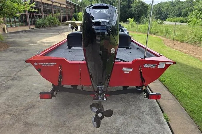 Slide: The Image of 2026 Tracker Pro Team 175 Crappie Edition boat, red exterior, parked on a driveway. - 6