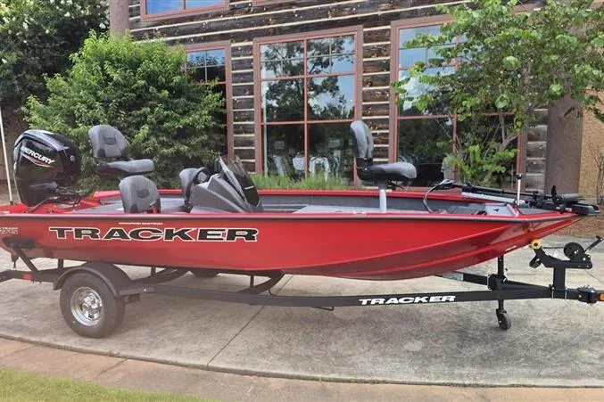 Slide: The Image of 2026 Tracker Pro Team 175 Crappie Edition boat, red, parked outdoors. - 2