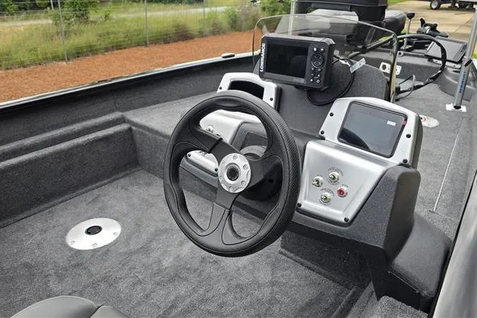Slide: The Image of 2026 Tracker Pro Team 175 Crappie Edition boat interior with steering wheel and control panel. - 4