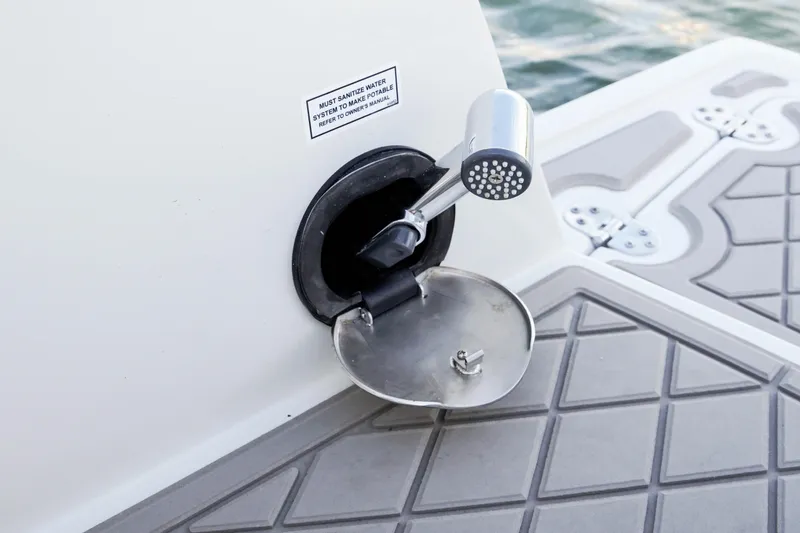 Slide: The Image of Outdoor shower on 2024 Finseeker 230 CC boat deck, with sanitization notice. - 13