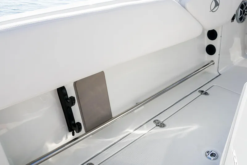 Slide: The Image of 2024 Finseeker 230 CC boat interior with sleek white seating and stainless steel rail. - 15