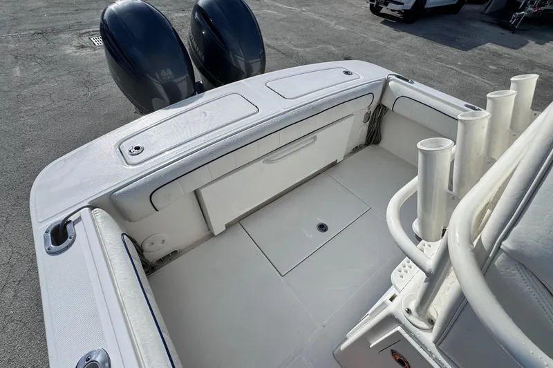 Slide: The Image of 2016 Regulator 25 boat deck with dual Yamaha engines and rod holders. - 11