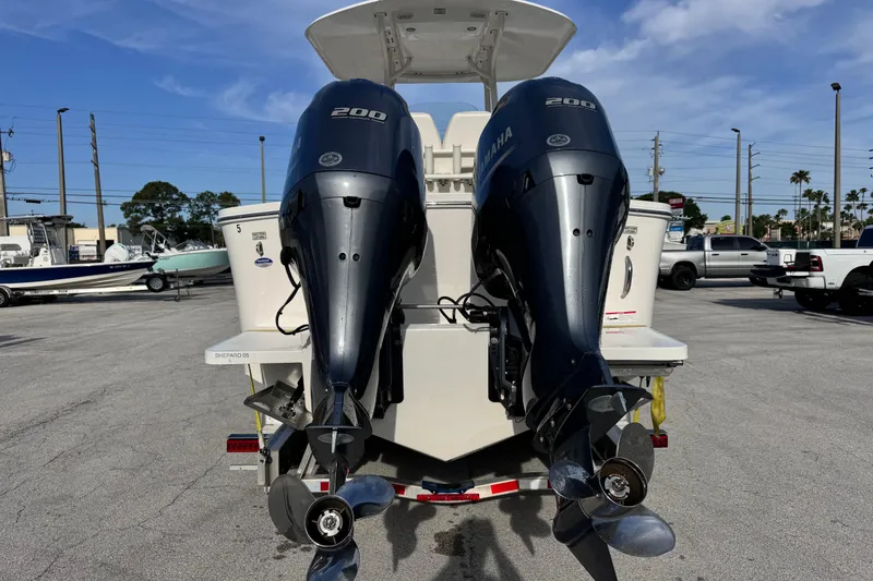 Slide: The Image of 2016 Regulator 25 boat with dual Yamaha 200 outboard engines in a parking lot. - 3