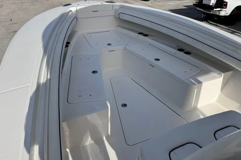 Slide: The Image of 2016 Regulator 25 boat interior with spacious seating and storage compartments. - 7