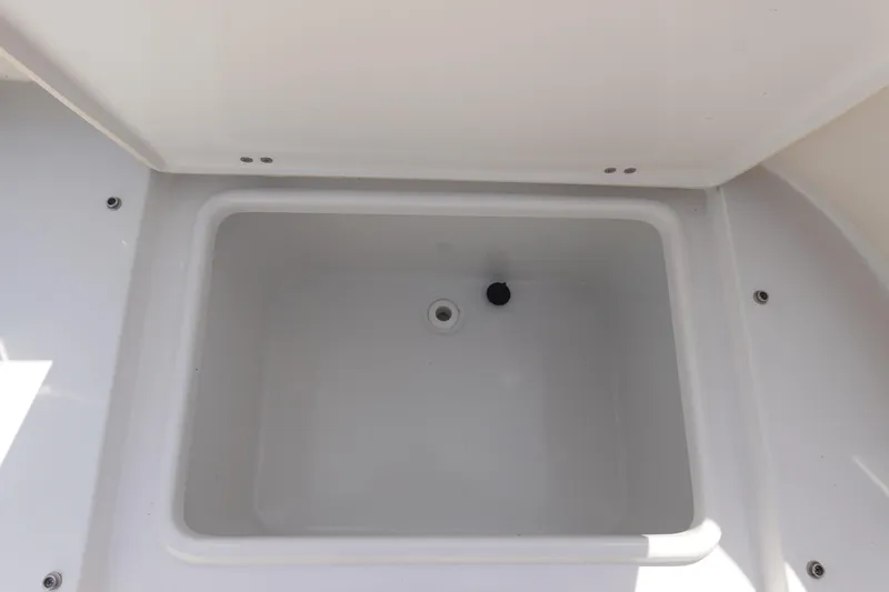 Slide: The Image of 2023 Sea Hunt Escape 28 boat storage compartment, open and empty. - 11