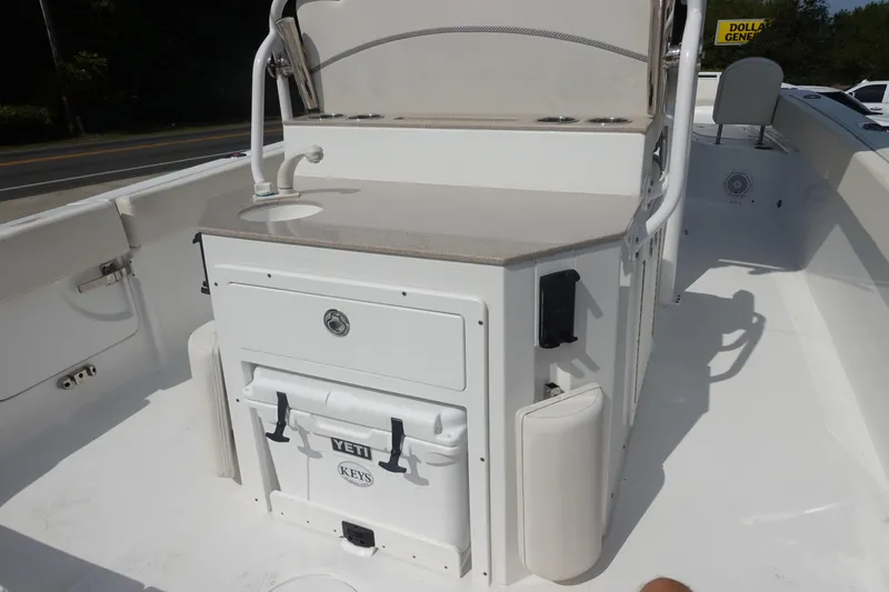 Slide: The Image of 2023 Sea Hunt Escape 28 boat interior with sink and Yeti cooler. - 12