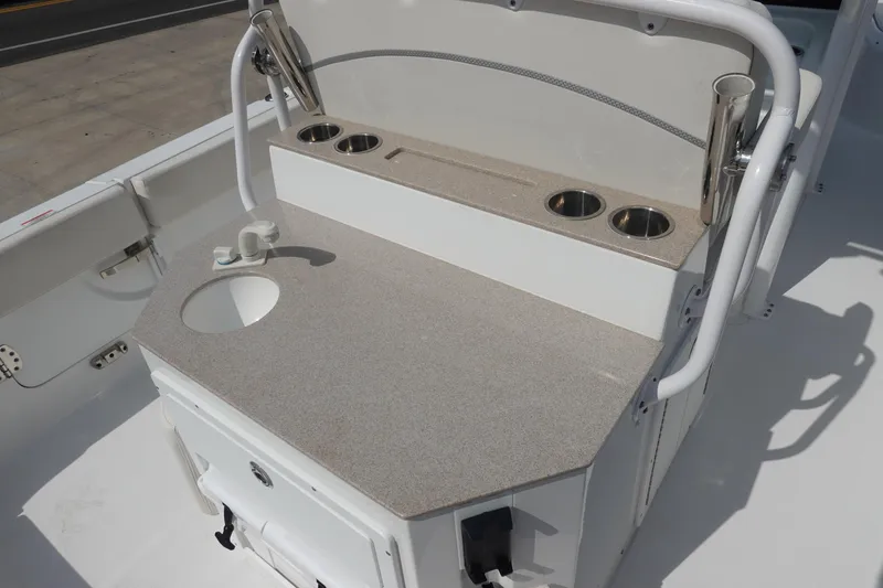Slide: The Image of 2023 Sea Hunt Escape 28 boat interior with sink and cup holders. - 13