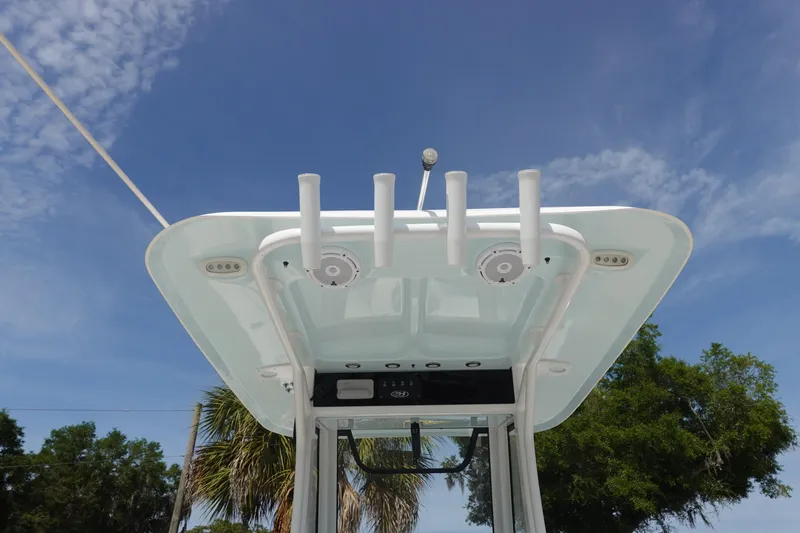 Slide: The Image of 2023 Sea Hunt Escape 28 boat top view with rod holders under clear blue sky. - 14