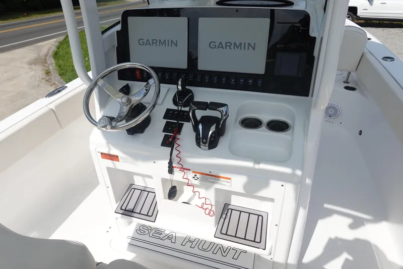 Slide: The Image of 2023 Sea Hunt Escape 28 boat console with Garmin displays and steering wheel. - 18