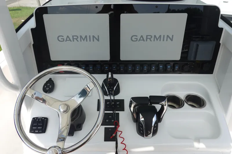 Slide: The Image of Helm of 2023 Sea Hunt Escape 28 with Garmin displays and dual throttle controls. - 19
