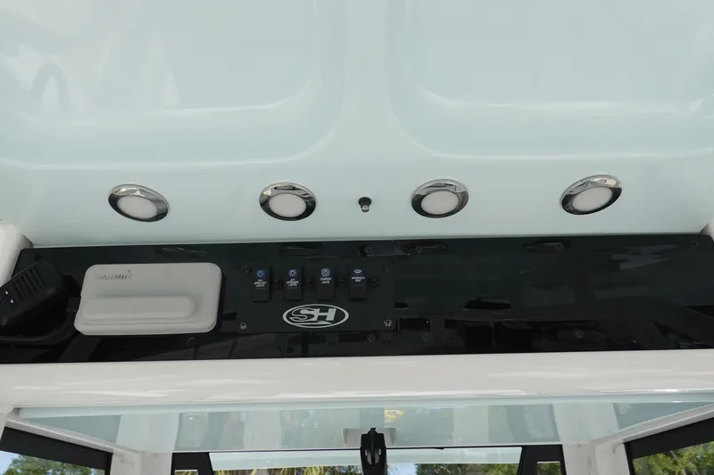 Slide: The Image of Control panel of 2023 Sea Hunt Escape 28 boat with switches and Garmin device. - 20