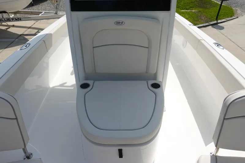 Slide: The Image of 2023 Sea Hunt Escape 28 boat seating area with cup holders, showcasing sleek design. - 22