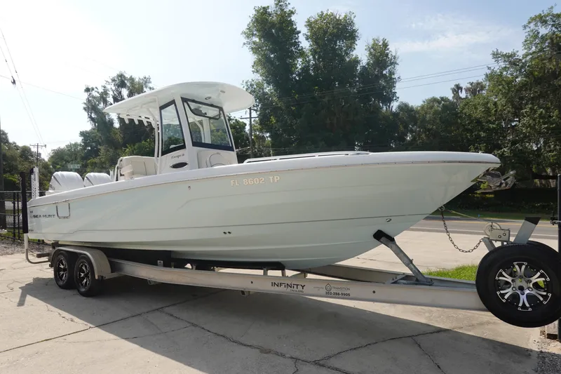 Slide: The Image of 2023 Sea Hunt Escape 28 boat on trailer, parked outdoors. - 3