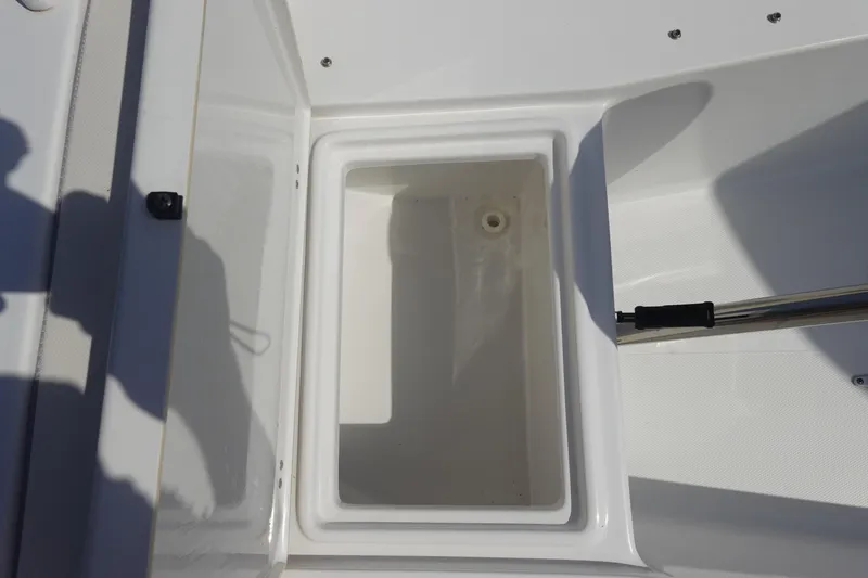 Slide: The Image of Open storage compartment on 2023 Sea Hunt Escape 28 boat, showcasing interior space. - 31