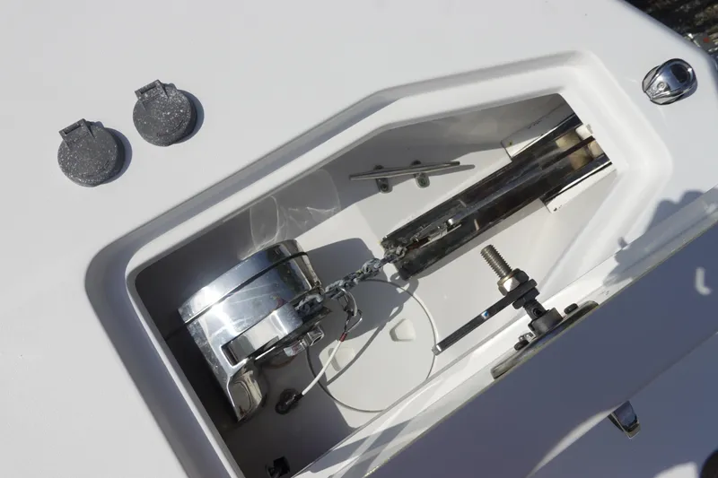 Slide: The Image of Anchor compartment of 2023 Sea Hunt Escape 28 boat, showcasing chain and winch mechanism. - 33